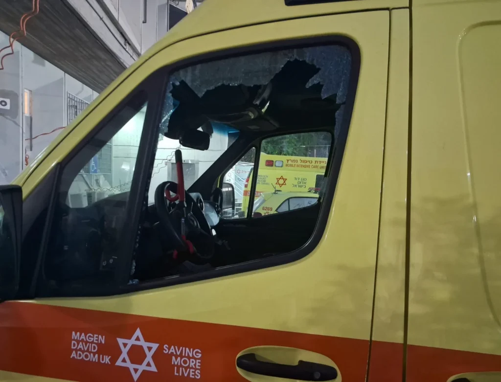 Yellow Magen David Adom ambulance with a smashed side window